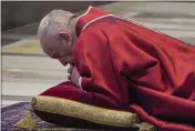  ?? ANDREW MEDICHINI — THE ASSOCIATED PRESS ?? Pope Francis lies down in prayer prior to celebrate Mass for the Passion of Christ at St. Peter’s Basilica at the Vatican on Friday.