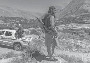  ?? VICTOR J. BLUE/THE NEW YORK TIMES ?? Taliban fighters from Mazar-i-Sharif patrol Tuesday in Afghanista­n’s Panjshir Valley.