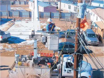  ?? COURTESY OF KIT CARSON ?? Kit Carson employee Jaime Mares works on a broadband network being installed in Taos designed to link several communitie­s and pueblos.