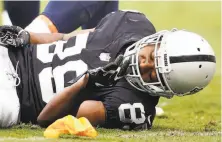  ?? D. Ross Cameron / Associated Press ?? Raiders wide receiver Amari Cooper remains on the ground after a dangerous hit. Cooper left the game with a concussion.