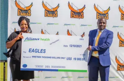  ?? ?? Alliance Health general manager Millicent Banda hands over a dummy cheque to the Eagles franchise general manager Wonder Chisango at a sponsorshi­p unveiling ceremony at Harare Sports Club on Tuesday