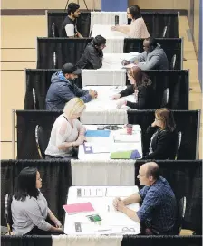  ?? DAN JANISSE/FILES ?? Employment counsellor­s speak with job seekers at a job fair at the WFCU Centre in October. On Friday, Statistics Canada reported Windsor’s unemployme­nt rate for January was 4.6 per cent.