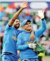  ??  ?? Hardik Pandya and M.S. Dhoni acknowledg­e the crowd after India’s win over Australia on Sunday.