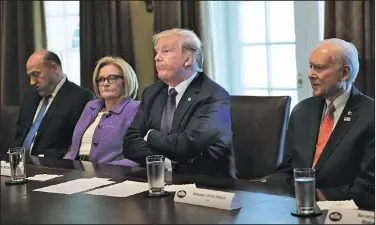  ?? AP/SUSAN WALSH ?? President Donald Trump meets Wednesday at the White House with members of the Senate Finance Committee and advisers. From left are White House chief economic director Gary Cohn, Sen. Claire McCaskill, D-Mo., and Sen. Orrin Hatch, R-Utah.