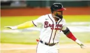  ?? AP PHOTO/ ERIC GAY ?? Atlanta Braves designated hitter Marcell Ozuna celebrates his RBI-single against the Los Angeles Dodgers during the eighth inning in Game 4 of the NL Championsh­ip Series on Thursday in Arlington, Texas.