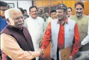  ?? KESHAV SINGH/HT ?? Chief minister Manohar Lal Khattar greets BJP’S Rajya Sabha nominee DP Vats after the latter filed his nomination at the Haryana Vidhan Sabha in Chandigarh on Monday.