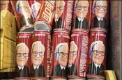  ?? DANIEL ACKER / BLOOMBERG ?? Cans of Coca-Cola from China bear a likeness of Warren Buffett, chairman and chief executive officer of Berkshire Hathaway, who is even more of an icon of success in China than in the U.S.