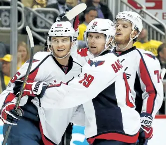  ?? GREGORY SHAMUS/GETTY IMAGES ?? Washington Capitals forward Andre Burakovsky, left, reacts after scoring a goal against the Pittsburgh Penguins with Nicklas Backstrom, (19) and John Carlson in Game 6 of the Eastern Conference Second Round during the 2017 NHL Stanley Cup Playoffs at...