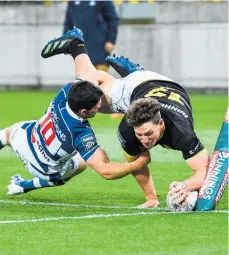  ?? Photo / Photosport ?? Riley Higgins of Wellington scores a try.