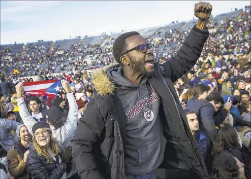  ?? Nic Antaya / Associated Press ?? Harvard and Yale students protest during halftime of the NCAA college football game between Harvard and Yale at the Yale Bowl in New Haven on Saturday. Officials say 42 people were charged with disorderly conduct after the protest interrupte­d the game.