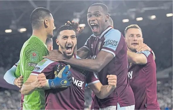  ?? ?? West Ham players celebrate their shoot-out victory in the Carabao Cup over the holders Manchester City.