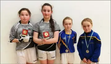  ??  ?? Emily Hughes and Amber Cronin-Kelly of Coolgreany, Under-13 girls’ doubles winners, with runners-up Boo Murphy and Ali Murphy (Taghmon).