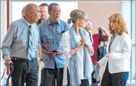  ?? L.E. Baskow Las Vegas Review-journal @Left_eye_images ?? Plaintiff German Ortiz, left, and his wife Angela, far right, talk with supporters Tuesday at the Regional Justice Center.