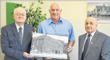  ?? ADAM MACINNIS/THE NEWS ?? Clyde Macdonald, left, and Philip MacKenzie, right, present MLA Pat Dunn with a photo of the former New Glasgow town hall and fire station.