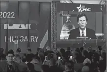  ?? SZILARD KOSZTICSAK/MTI VIA AP ?? Tucker Carlson on screen delivering a speech Thursday at the CPAC conference in Budapest, Hungary.