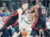  ?? MICHAEL DWYER/AP ?? Bam Adebayo screens the Celtics’ Marcus Smart as Tyler Herro drives during the Heat’s win in Game 3 of the Eastern Conference finals Saturday in Boston.