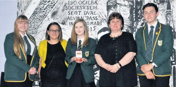  ??  ?? Honour Presenting Dionne Hossack with her Junior Leadership Team Medal are (l-r) Erin Connor (senior depute head girl), Angela Tierney (chair of the parent council), Dionne Hossack (junior head girl), Laura Gaddis (president of the PTA) and Joseph...