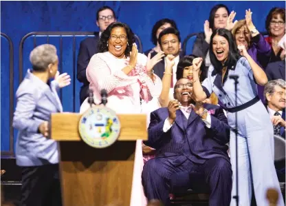  ?? ASHLEE REZIN/SUN-TIMES ?? City Treasurer Melissa Conyears-Ervin and City Clerk Anna Valencia cheer as Mayor Lori Lightfoot mentions the number of women of color in top Chicago and Cook County offices during her inaugural address at Wintrust Arena, Monday.