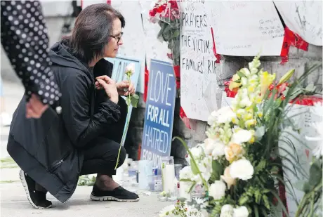  ?? LARS HAGBERG/AFP/GETTY IMAGES ?? A woman prays Tuesday at a makeshift memorial for victims in Monday’s van attack in Toronto.