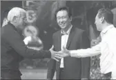  ?? XINHUA ?? Marcello Lippi, aWorld Cup-winning coach, shakes hands with Cai Zhenhua, president of the Chinese Football Associatio­n, in Guangzhou, Guangdong province, on Sunday, as Xu Jiayin, chairman of Evergrande Group, looks on. Lippi was hired as coach of the...