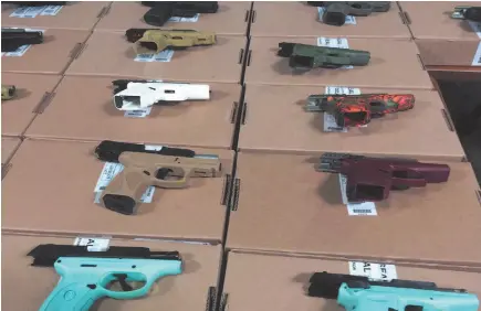  ?? CP FILE PHOTO ?? A new Statistics Canada report says the national murder rate reached its highest point in a decade last year thanks to a spike in the number of deaths from guns and gangs. Seized firearms are seen on display during a Toronto Police Service press conference in June.