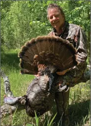  ?? (Arkansas Democrat-Gazette) ?? The author finished his Arkansas spring turkey season Thursday by calling up a hen with this gobbler in tow.