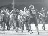  ?? ORLANDO SENTINEL ?? Seminole players and coaches celebrate after recovering a Lake Mary fumble in a regular-season victory against the Rams. Seminole won again in a Class 8A region semifinal.