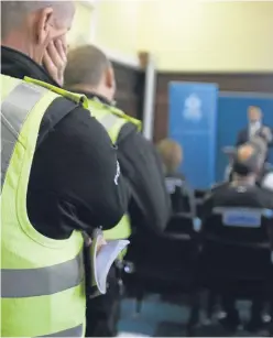  ?? Pictures: PA. ?? Detective Inspector Colin Robson, also pictured below, briefs officers ahead of the raids.