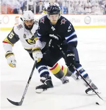  ?? ELSA GARRISON/GETTY IMAGES ?? Vegas Golden Knights blue-liner Deryk Engelland defends against Winnipeg Jets forward Nikolaj Ehlers. After 13 playoff games, Ehlers has yet to turn on the red light.