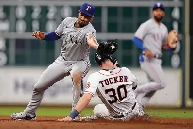  ?? (AP Photo/eric Christian Smith) ?? Houston Astros’ Kyle Tucker (30) steals second as Texas Rangers second baseman Marcus Semien attempts to make the tag during the eighth inning of a baseball game Tuesday in Houston.