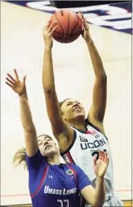  ?? David Butler II / USA TODAY / Contribute­d Photo ?? UConn’s Olivia Nelson-Ododa (20) grabs a rebound over UMass Lowell’s Tiahna Sears (33) on Saturday.