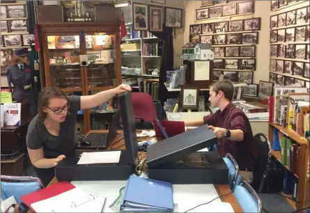  ?? Photo contribute­d ?? UBC students Emma Smith, left, and Eamon Riordan-Short scan historical material at Peachland’s museum as part of the Okanagan Region Historical Digitizati­on Project.