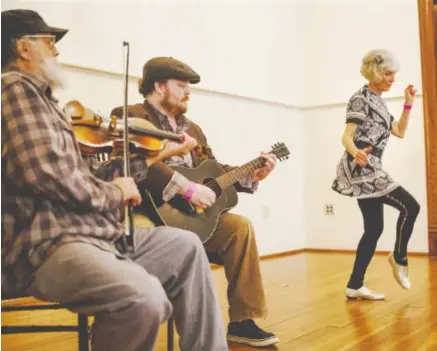  ?? STAFF FILE PHOTO ?? Mick Kinney, left, and his son, Evan Kinney, play music while Laurie Jo Ramond competes in the dance contest in a previous Great Southern Old Time Fiddlers Convention. The 2020 competitio­n is March 14 at 901 Lindsay.
