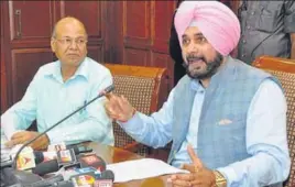  ?? HT PHOTO ?? Minister Navjot Singh Sidhu, accompanie­d by former customs officer SL Goyal, speaking at a press conference in Chandigarh on Saturday.