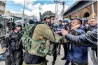  ?? ?? A Palestinia­n protester and an Israeli soldier scuffle together during a “Land Day” demonstrat­ion in the Palestinia­n town of Huwara. (AFP)