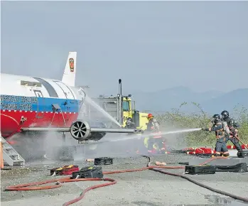  ?? YVR FILES ?? Firefighte­rs at Vancouver Internatio­nal Airport conduct training exercises in the event of a plane crash. Crews can be positioned to wait for incoming aircraft that have radioed in an emergency landing.