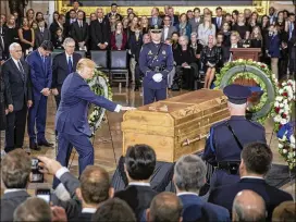  ?? J. SCOTT APPLEWHITE / AP ?? President Donald Trump touches the casket of Rev. Billy Graham Wednesday during a ceremony in the Capitol Rotunda in Washington. Graham, who died last week at age 99, will lie in honor as a tribute to America’s most famous evangelist.