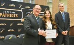  ?? APRIL GAMIZ/MORNING CALL PHOTOS ?? Roy and Grigsby present Freedom High School’s Melony Nonnemache­r as a Superinten­dent’s Scholarshi­p winner Friday during a ceremony at Freedom High School in Bethlehem.