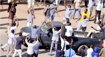  ??  ?? File photo shows Sudanese demonstrat­ors chanting slogans as they march along the street during anti-government protests in Khartoum. — Reuters photo