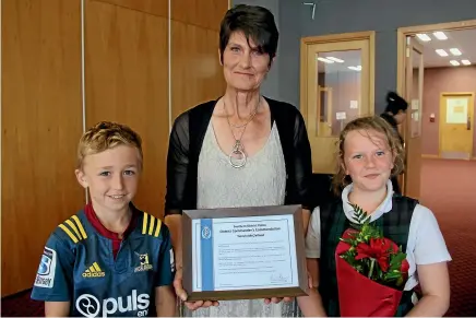  ??  ?? New Zealand Police district commanders commendati­on recipient Yvonne McClelland with her two grandchild­ren, Tyler Wakingshaw and Charlee Hegarty, both 9, at the Police awards ceremony at Invercargi­ll yesterday. MARY-JO TOHILL/STUFF