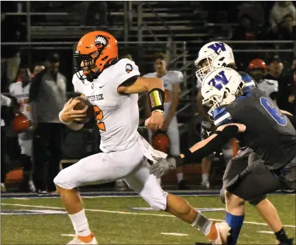  ?? MATTHEW B. MOWERY — MEDIANEWS GROUP FILE PHOTO ?? Birmingham Brother Rice quarterbac­k Blake Marrogy (2) pulls away from a pair of Walled Lake Western defenders in their Division 3district championsh­ip game on Nov. 4. Rice won, 30-22, continuing its playoff run for another game.