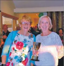  ?? ?? Fiona Henderson presents Alice Anderson with the Shiskine Club Trophy.