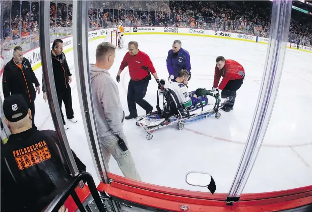  ?? — THE ASSOCAITED PRESS ?? Canucks defenceman Alex Edler is carted off the ice on a stretcher after crashing to the ice face-first during the third period of Monday night’s loss to the Philadelph­ia Flyers. Edler received stitches and suffered a concussion, but no facial fractures.