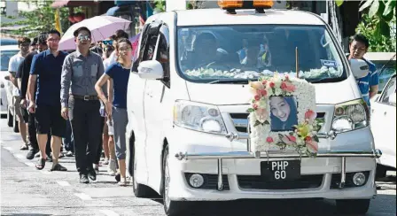  ??  ?? Painful loss: Family and friends walking behind the car carrying Joice’s coffin. (Right) Joice’s parents and brother weeping and chanting as her coffin was pushed into the cremation chamber of Batu gantung crematoriu­m.