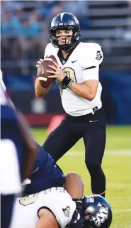  ??  ?? UCF junior quarterbac­k McKenzie Milton passed for five touchdowns to lead the Knights in Thursday’s road win.