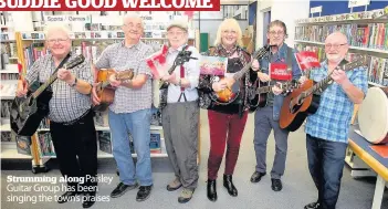  ??  ?? Strumming along Paisley Guitar Group has been singing the town’s praises All smiles