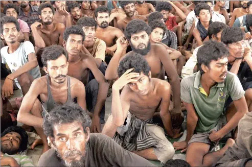  ?? PICTURES: ZIKRI MAULANA / EPA ?? SAVED: Migrants from Myanmar and Bangladesh at a police station in Langkawi, Malaysia, yesterday. Four boats carrying some 1 400 Rohingya migrants were rescued off the coasts of Indonesia and Malaysia, officials said.