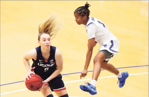  ?? Noah K. Murray / Associated Press ?? UConn guard Paige Bueckers (5) gets by Seton Hall’s Lauren Park-Lane (3) on Tuesday night in South Orange, N.J.