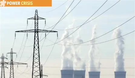  ?? — Reuters ?? Electrical power pylons of high-tension electricit­y power lines are seen near the cooling towers of the Dampierre nuclear power plant.