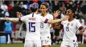  ?? CHRIS CARLSON / AP ?? U.S. forward Megan Rapinoe celebrates after scoring with Lynn Williams and Crystal Dunn during the second half of a women’s Olympic qualifying soccer match Feb. 9 against Canada in Carson, Calif. The U.S. won 3-0.